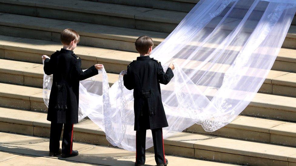 Pageboys John and Brian Mulroney lift train of Meghan Markle's dress