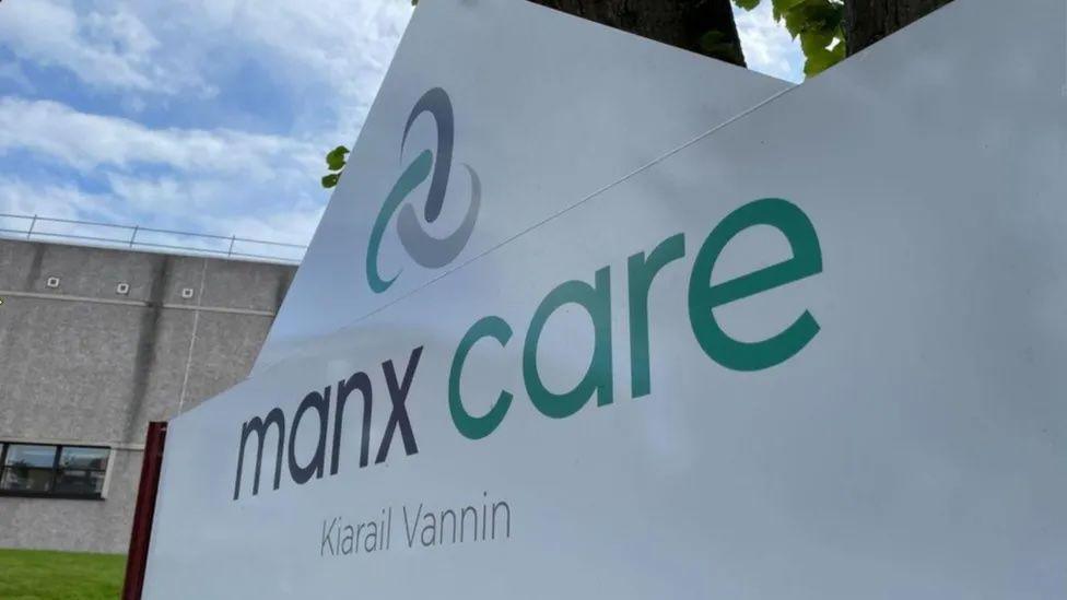 A close up of a large white sign that reads Manx Care. 