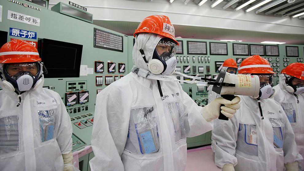 A worker measuring radiation levels at the Fukushima Daichi nuclear power station in 2014