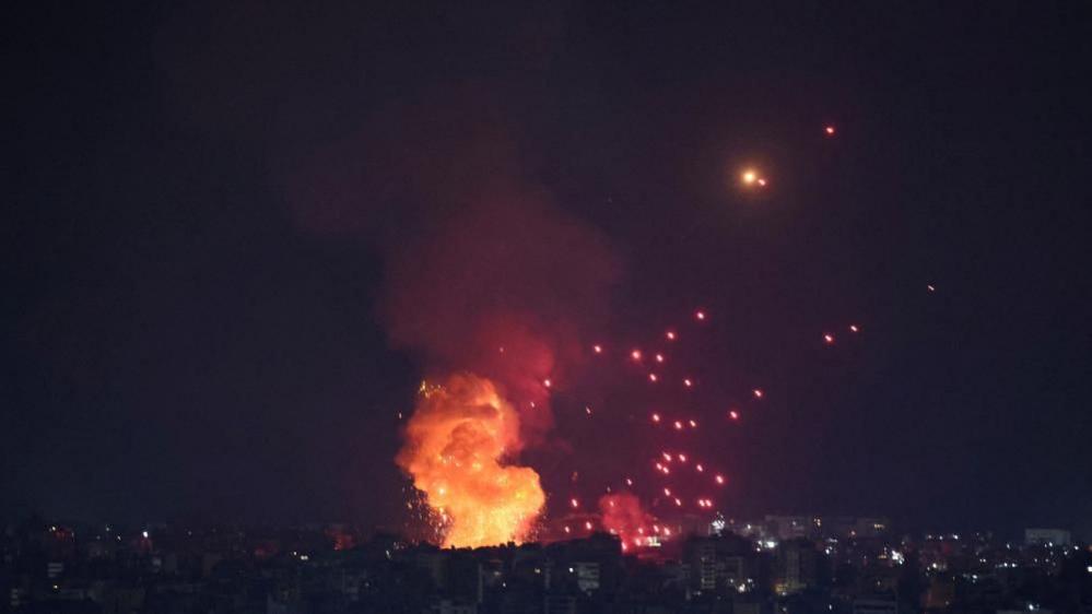 A large explosion is seen over Beirut after Israeli air strikes in the capital.