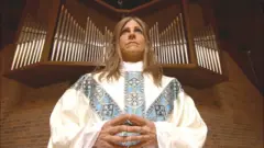 Anne Tropeano stands infront of an organ