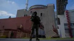 A Russian serviceman stands guard at Zaporizhzhia Nuclear Power Station in Energodar on May 1, 2022 (picture was taken during a media trip organised by the Russian army)