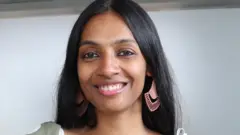 Pallavi sitting on a chair in her coaching room