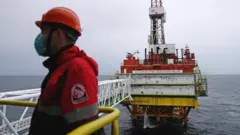 An employee is seen at an oil platform operated by Lukoil company at the Kravtsovskoye oilfield in the Baltic Sea, Russia