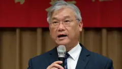 Newly appointed chairman of Taiwan's Mainland Affairs Council (MAC) Andrew Hsia (R) speaks during a ceremony in Taipei on February 17, 2015.