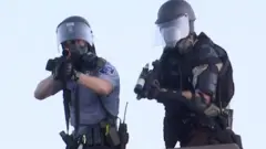 Police aim at a Reuters TV cameraman during nationwide unrest following the death of of George Floyd in Minneapolis police custody, in Minneapolis, Minnesota,