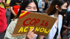 People participate in a rally during a global day of action on climate change in Melbourne on November 6, 2021