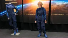 Ketty Maisonrouge trying on her spacesuit for the first time