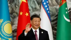 Chinese President Xi Jinping waves while posing for pictures at a group photo session during the China-Central Asia Summit in Xi"an, Shaanxi province, China, 19 May 2023.