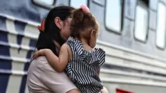 Mother and child evacuating from Ukrainian city Pokrovsk in Donetsk region, as the occupying Russian army approaching, September 2024.