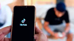 People use the TikTok app on smartphones