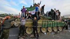 People celebrate with anti-government fighters at Umayyad Square in Damascus on 8 December 2024