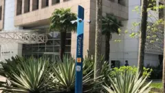 Poste azul da empresa CoSecurity instalado em frente a prédio