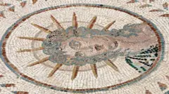 Mosaico mostra uma figura com tiara de sol