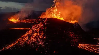 Lava spews from multiple craters of the Sundhnúkur volcano on June 3, 2024 on the Reykjanes peninsula near Grindavik, Iceland. 