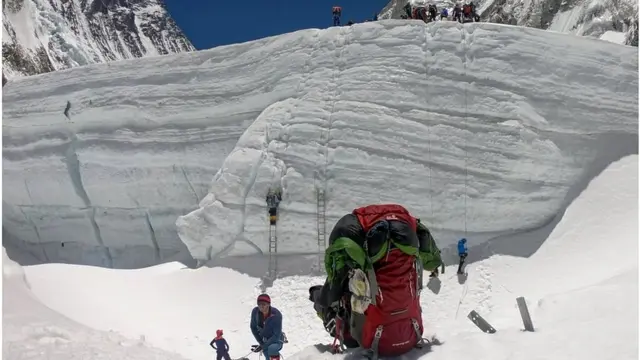 Mountaineers close to Camp 2 prepare to ascend steep ladders towards Camp 3