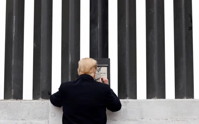 Rear view of Donald Trump as he signed a plaque on the US-Mexico border wall in Alamo, Texas, in January 2021