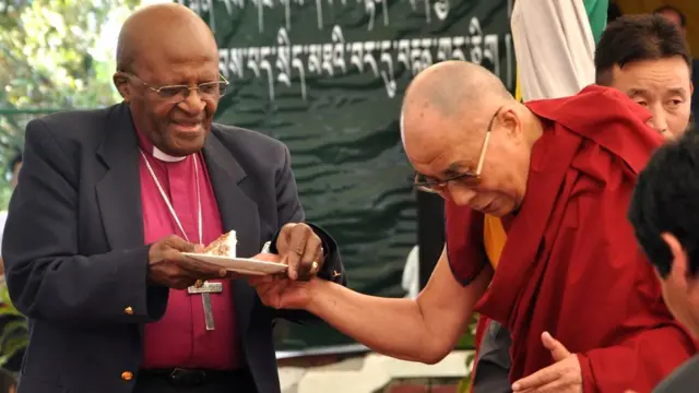 Spiritual leader Dalai Lama shares his birthday cake with retired Archbishop Desmond Tutu at the Tibetan Children's Village School in Dharmsala, India, 23 April 2015