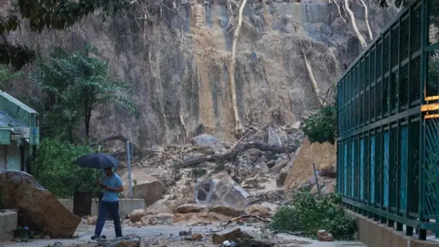 A man walks past the debris of a landside in Hong Kong