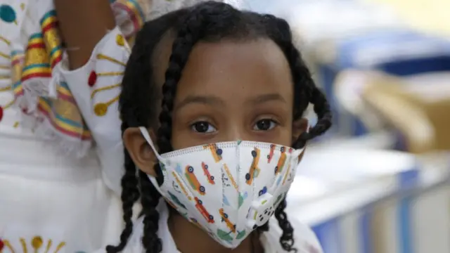 People wearing face masks as a precautionary measure against the coronavirus (Covid-19) come to Entoto Kidane Mehret Church as Ethiopian Orthodox Christians celebrate Filseta Day after the end of fasting for 15 days without consuming animal products in commemoration of Assumption of Mary in Addis Ababa, Ethiopia on August 22, 2020