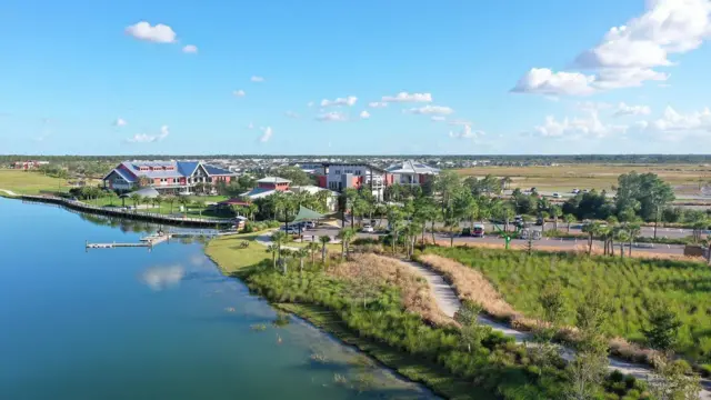 Foto mostra cidade com muito verde sob céu azul