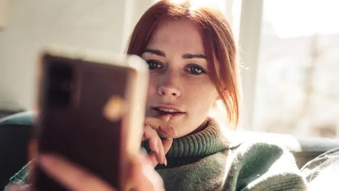 Woman using smartphone (stock image)