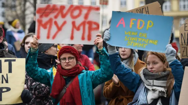 Young people in Erfurt hold placards reading "Not my MP" (L) and "A FD P" on 6 Feb 2019