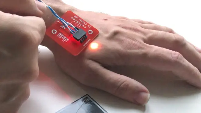 Mr Paumen's has a contactless chip under the skin of his left hand, and it lights up when a payment is made