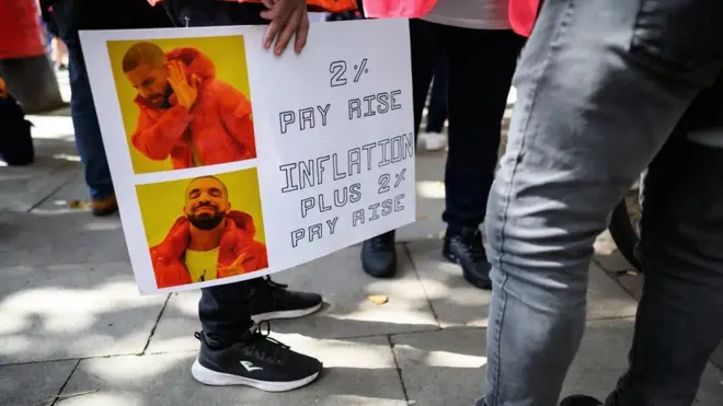 Manifestante segura cartaz com meme em protesto