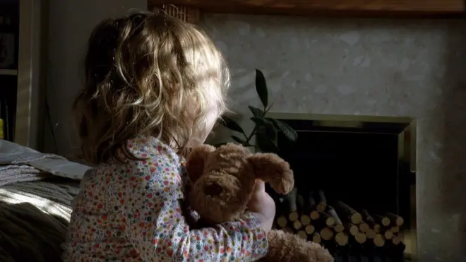 Girl holding teddy bear