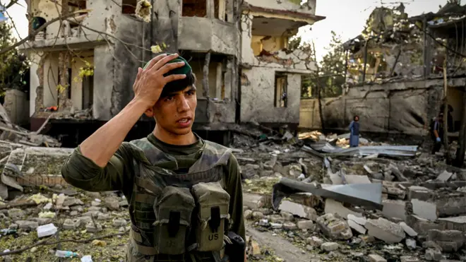 An Afghan security personnel gestures as he stands guard at the site a day after a car bomb explosion in Kabul on 4 August 2021