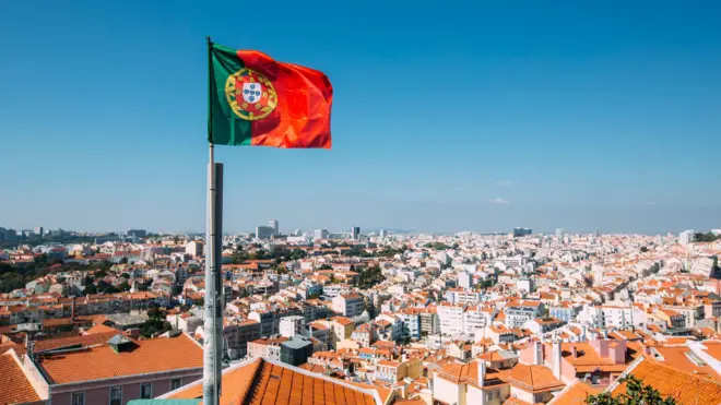 bandeira de Portugal com Lisboa ao fundo 