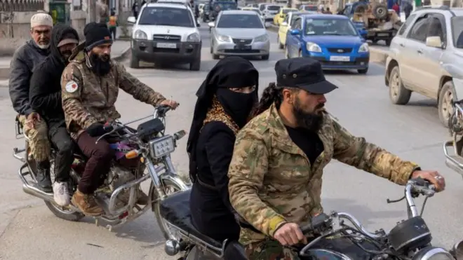 Dois grupos de pessoas andam de moto por uma rua em Idlib, em 16 de dezembro