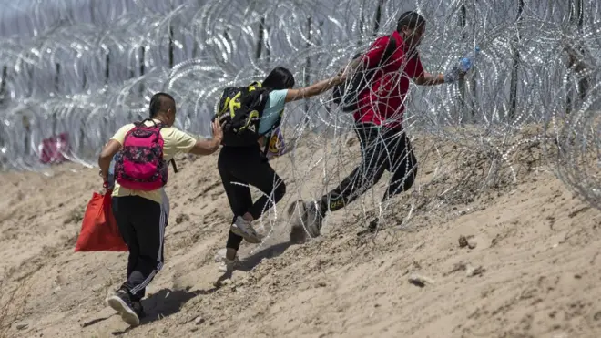 Image shows people at the border near El Paso, Texas