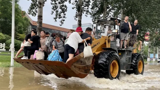 Residents rescued on a bulldozer