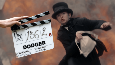 Dodger is jumping away from an explosion. There is a film clapped board which reads "Dodger"