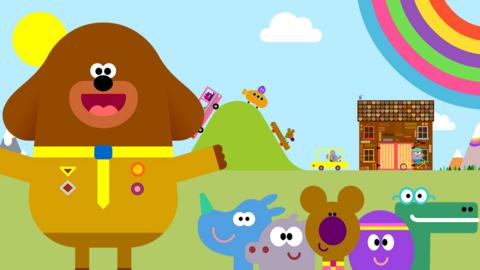 Hey Duggee and the squirrels with the hut, animals and a rainbow in the background.