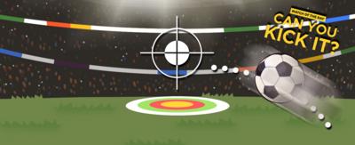 An in-game rendering of a football pitch with an audience. In the middle is a target on the ground and a target above it with a football connected with a dotted line.