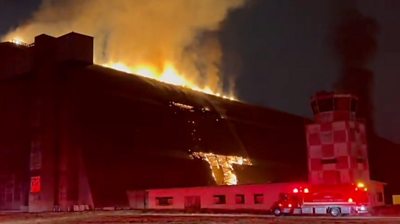 Fire seen bursting out the top of hangar
