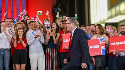 Sir Keir Starmer walks in front of supporters