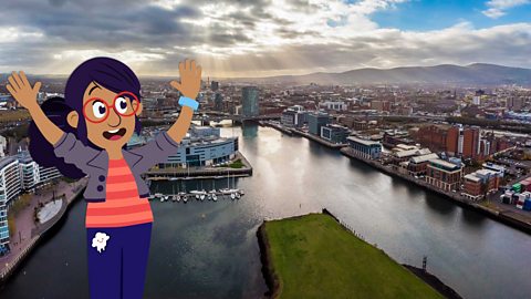 Sara standing next to a photo of Belfast