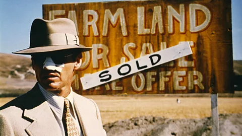 Jack Nicholson in front of "Farmland sold" sign (Credit: Alamy)