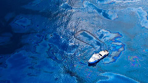 A skimmer boat corals oil after the Deepwater Horizon spill (Credit: Getty Images)