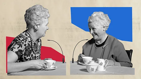 Two elderly women talk and drink tea (Credit: Javier Hirschfeld/Getty Images)