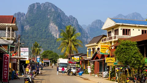 A neighbourhood in Vang Vieng, Laos lined with guesthouses (Credit: Getty Images)