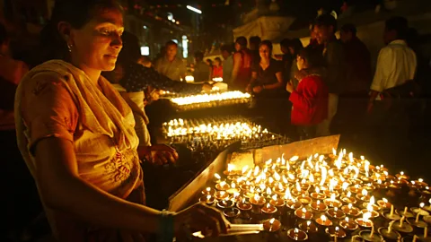 Paula Bronstein/Getty Lighting prayer candles for the Buddha's birthday (Credit: Paula Bronstein/Getty)