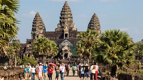 Alamy Angkor Wat is the largest religious complex in the world, covering a space of 500 acres (2 sq km) – it was initially  built as a Hindu temple to honour Vishnu (Credit: Alamy)