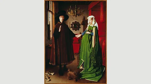 Getty Images In The Arnolfini Portrait, Jan van Eyck uses green to symbolise fertility, although scholars believe the woman in it is not pregnant (Credit: Getty Images)