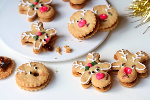 a selection of reindeer mince pie biscuits decorated with reindeer faces