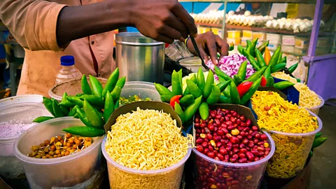 Arindam Ghosh/Getty Images The jhal-muri wallah is often as much of a draw as the snack, with some vendors commanding cult followings (Credit: Arindam Ghosh/Getty Images)